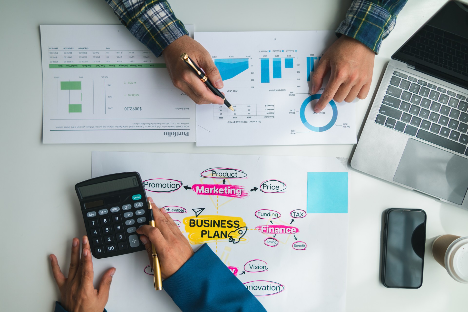 Businessmen and investors form a group of startups and business plans together in a meeting room. A group of startup entrepreneurs are discussing investment plans and profits.